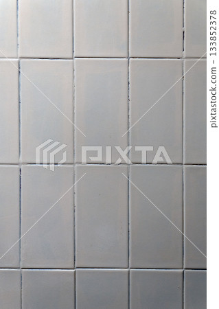 White vertical wall tiles with dark grout lines White vertical wall tiles with dark grout lines 133852378
