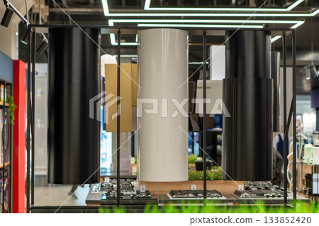 An eye-level shot of modern cylindrical range hoods 133852420