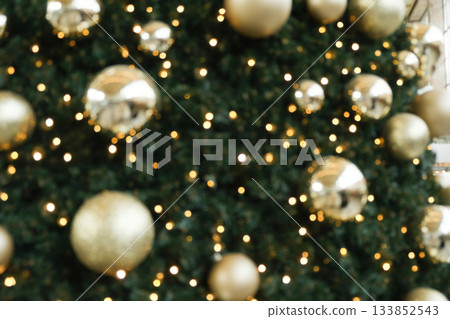 Festive Christmas Bokeh Background with Golden Ornaments and Sparkling Lights. Festive Christmas Bokeh Background with Golden Ornaments and Sparkling Lights. 133852543