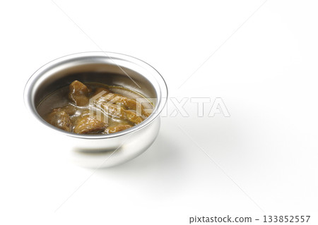 Chicken curry served in silver dish photographed against a white background 133852557
