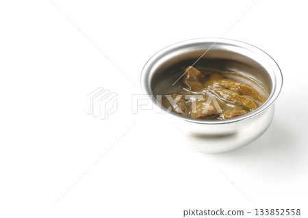 Chicken curry served in silver dish photographed against a white background 133852558