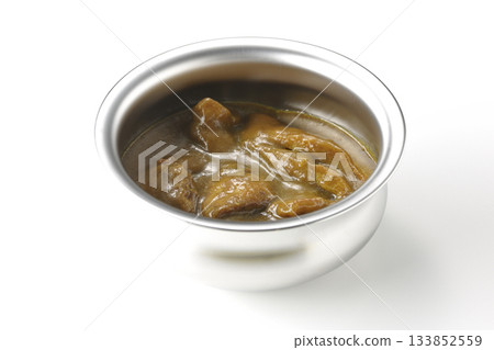 Chicken curry served in silver dish photographed against a white background 133852559