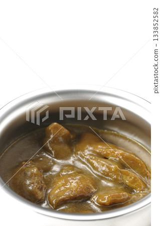 Chicken curry served in silver dish photographed against a white background 133852582
