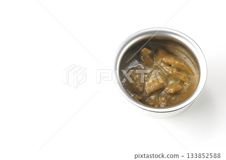 Chicken curry served in silver dish photographed against a white background 133852588