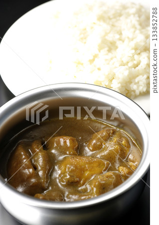 Chicken curry and rice served on silver tableware Chicken curry and rice served on silver tableware 133852788