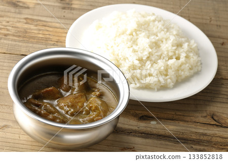 Chicken curry and rice served on silver tableware Chicken curry and rice served on silver tableware 133852818