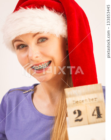 Happy woman holding 24 december date Happy woman holding 24 december date 133853445