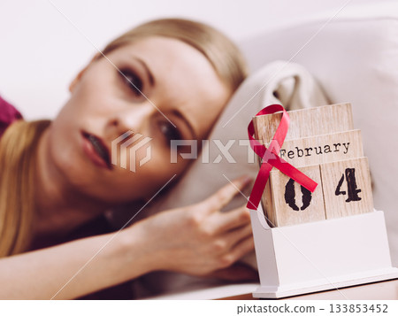Woman on bed, world breast cancer day on calendar Woman on bed, world breast cancer day on calendar 133853452