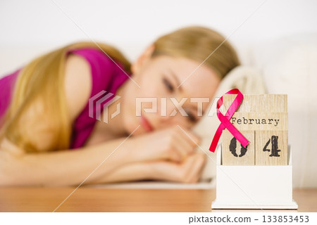 Woman on bed, world breast cancer day on calendar Woman on bed, world breast cancer day on calendar 133853453