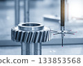 The CMM machine measuring the metal gear parts by modular probe in the light blue scene. 133853568