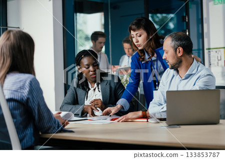 Black Female Manager Leading Feedback Session as Student Intern Joins Team Black Female Manager Leading Feedback Session as Student Intern Joins Team 133853787