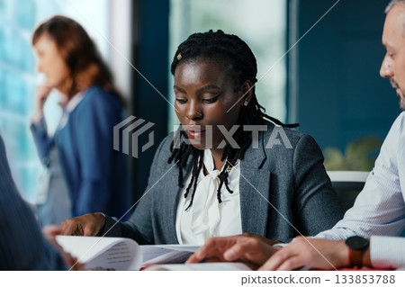 Black Female Manager Providing Feedback to Junior Employee in Multicultural Office Black Female Manager Providing Feedback to Junior Employee in Multicultural Office 133853788