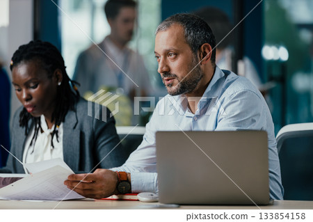 Senior Management Team Leading New Employee Feedback Session in Modern Open Plan Office Senior Management Team Leading New Employee Feedback Session in Modern Open Plan Office 133854158