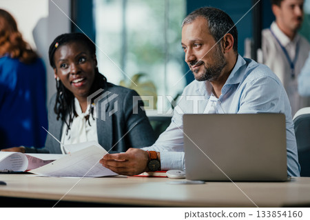 Smiling Black Woman Leading Feedback Session Meeting in Modern Open Office 133854160