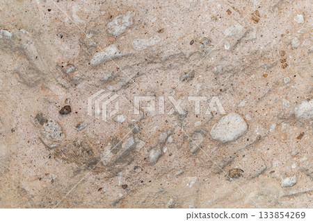 A close up of a stone wall with a lot of texture and a few small holes A close up of a stone wall with a lot of texture and a few small holes 133854269