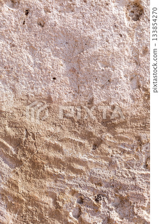 A wall with a rough texture and a few small holes A wall with a rough texture and a few small holes 133854270