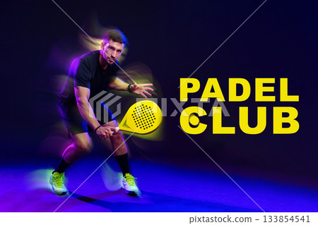 Dynamic player demonstrating skills at padel club during indoor match 133854541