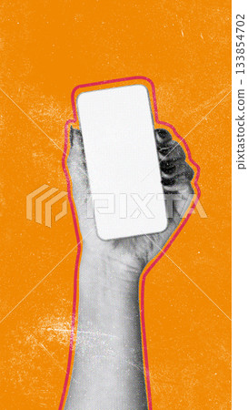Hand holding a blank smartphone against an orange background in a creative display 133854702