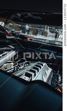 Engine components are visible in a car's hood during maintenance or inspection 133854732