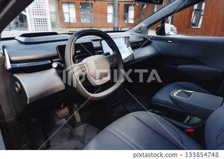 Modern electric vehicle interior showcases stylish design and advanced features 133854748