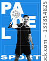Man playing paddle sport with racket on blue background showing enthusiasm for the game 133854825