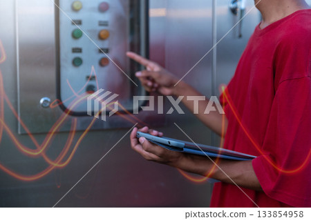 Electrical engineer working in control room.  133854958