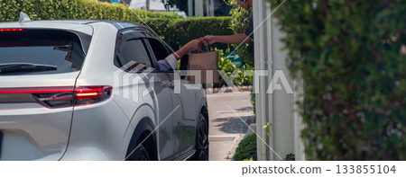 Hand Man in car receiving coffee in drive thru fast food restaurant. Hand Man in car receiving coffee in drive thru fast food restaurant. 133855104