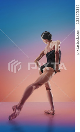 Contemporary dancer in dynamic back-lean pose on multicolor gradient 133855355
