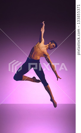 Ballet dancer in expansive high kick with flowing fabric on neon blue-violet stage Ballet dancer in expansive high kick with flowing fabric on neon blue-violet stage 133855371