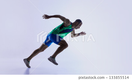 Runner stepping into low start posture before sprint Runner stepping into low start posture before sprint 133855514
