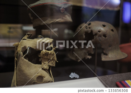 Military helmet and equipment with bullet holes 133856308