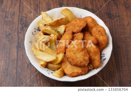 Chicken cutlet and french fries 133856704