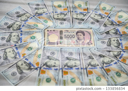 Japanese female leader surrounded by men on the $100 bill and the $5000 bill (slightly blurred) 133856834