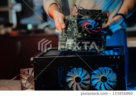 Man assembles a computer system unit at home 133856860