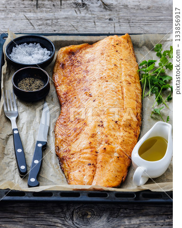 roasted whole salmon fillet on baking sheet 133856917