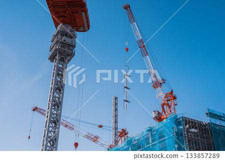 Construction site and crane lifting operations 133857289