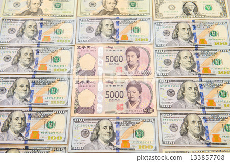 100, 20, and 1 dollar bills; Japanese 5,000 yen bill featuring a female leader surrounded by male leaders; slightly blurred 133857708