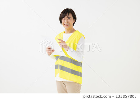 A woman wearing a reflective vest A woman wearing a reflective vest 133857805