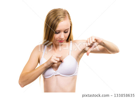 Woman dissatisfied with size of bra breasts 133858635