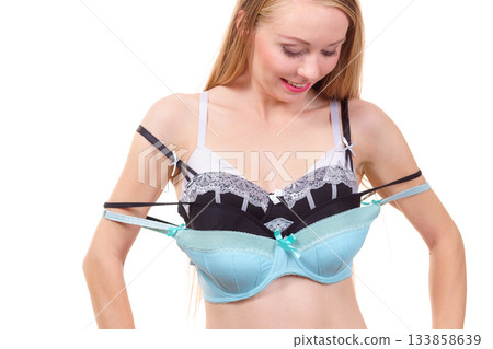 Woman holds bras, choosing Woman holds bras, choosing 133858639