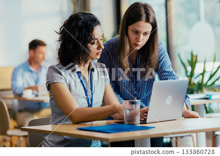 Three Team Members Celebrating Successful Conference Presentation at Venue Cafe 133860728
