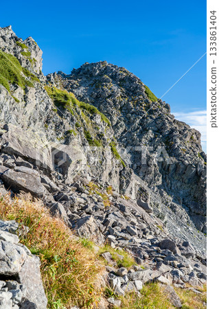 View of the summit of Mount Kitahotaka from Nanryo Terrace. Climbing Mount Kitahotaka in the Northern Alps. 133861404