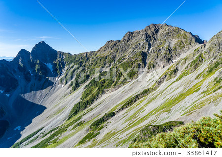 View of Mount Okuhotaka and Mount Maehotaka from the Minamiryo hiking trail of Mount Kitahotaka. Climbing Mount Kitahotaka in the Northern Alps View of Mount Okuhotaka and Mount Maehotaka from the Minamiryo hiking trail of Mount Kitahotaka. Climbing Mount Kitahotaka in the Northern Alps 133861417