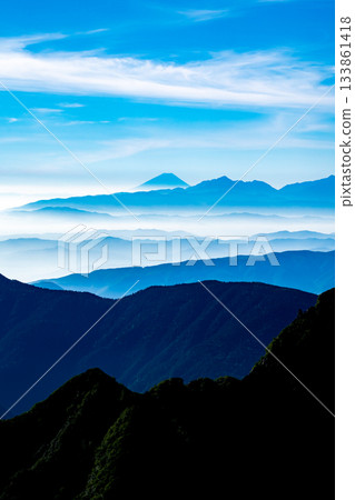 Mount Fuji and the Southern Alps seen from the Minamiryo hiking trail of Mount Kitahotaka. Climbing Mount Kitahotaka in the Northern Alps. Mount Fuji and the Southern Alps seen from the Minamiryo hiking trail of Mount Kitahotaka. Climbing Mount Kitahotaka in the Northern Alps. 133861418