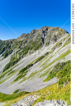 從北穗高岳南嶺登山道眺望奧穗高岳和聖天嶽。攀登北阿爾卑斯山的北穗高岳 從北穗高岳南嶺登山道眺望奧穗高岳和聖天嶽。攀登北阿爾卑斯山的北穗高岳 133861565