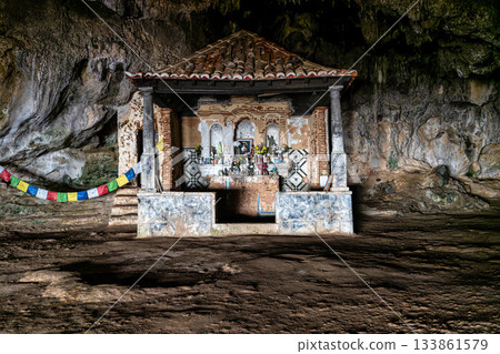 Dark interior of Lapa de Santa Margarida in Arrabida, Setubal, Portugal. Cave with small chapel of spontaneous worship Dark interior of Lapa de Santa Margarida in Arrabida, Setubal, Portugal. Cave with small chapel of spontaneous worship 133861579