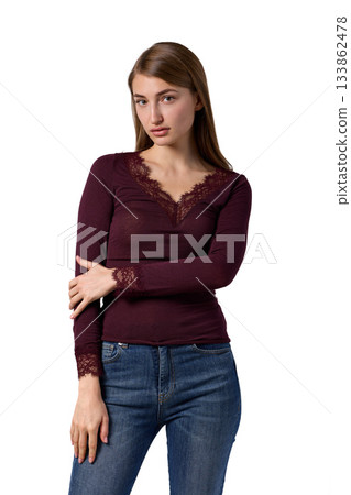 Slavic woman in burgundy lace top and jeans 133862478