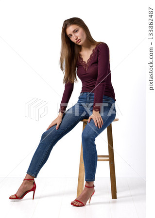 Slavic fashion model seated in studio portrait 133862487