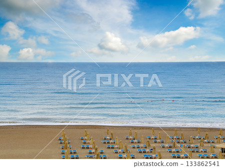 Idyllic Seascape View of Sandy Beach, Ocean Waves, and Blue Sky 133862541