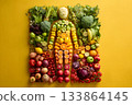 A vegan figure made from fresh fruits and vegetables stands tall. 133864145